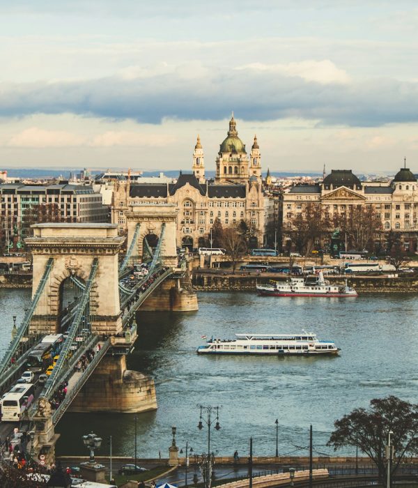 bridge over body of water in front of buildings