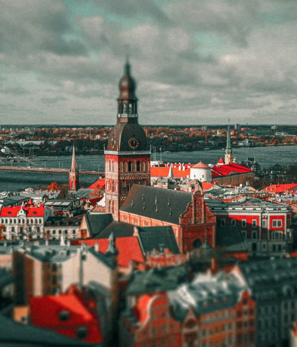 an aerial view of a city with a bridge in the background