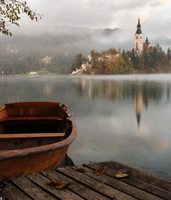 brown wooden boat floating on body of water